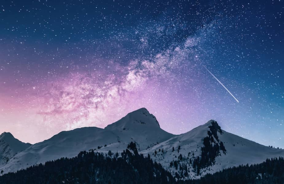 Mountains with snow and clear sky with stars