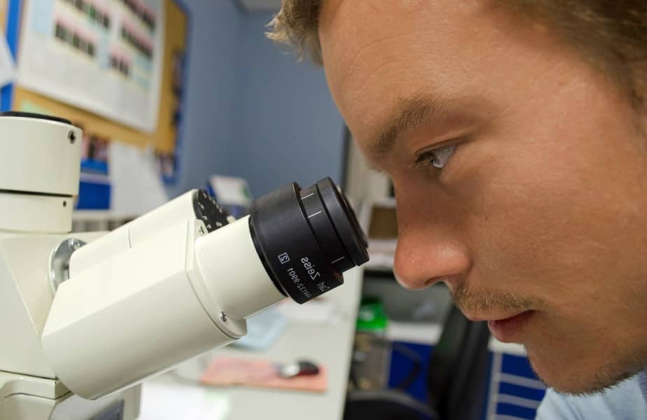 Researcher looking in to a telescope